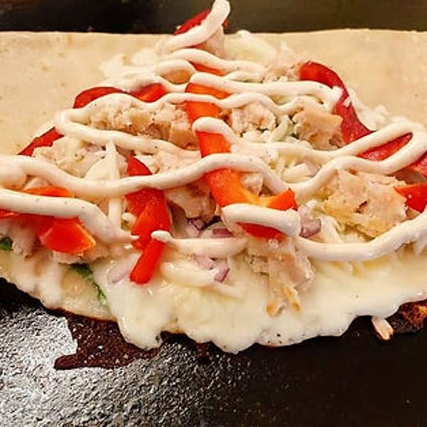 Savory Crepery crepe filled with chicken, red peppers, cheese, and drizzled with white sauce.